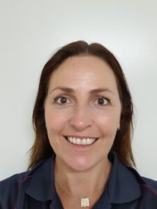 Woman with dark hard smiling at camera in selfie