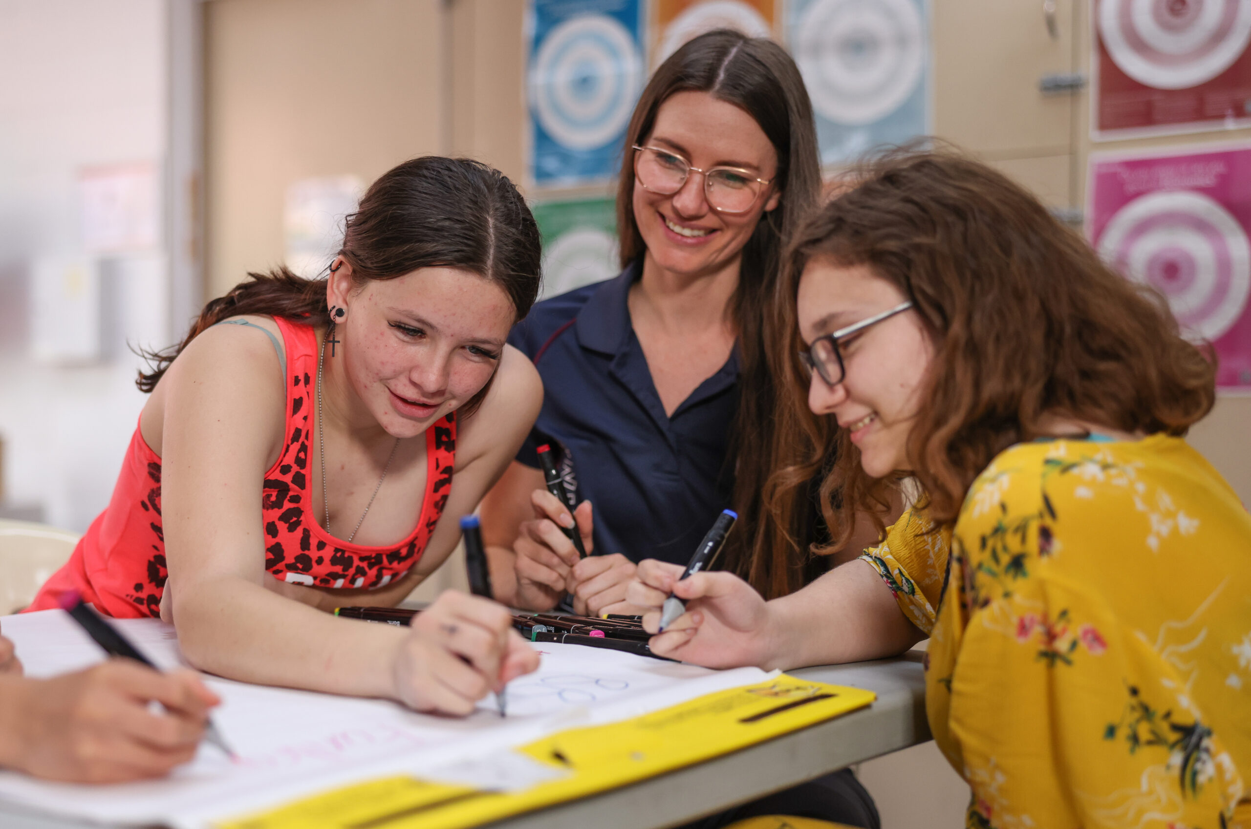Get Set for Work - two girls and a mentor drawing or writing on a big piece of paper