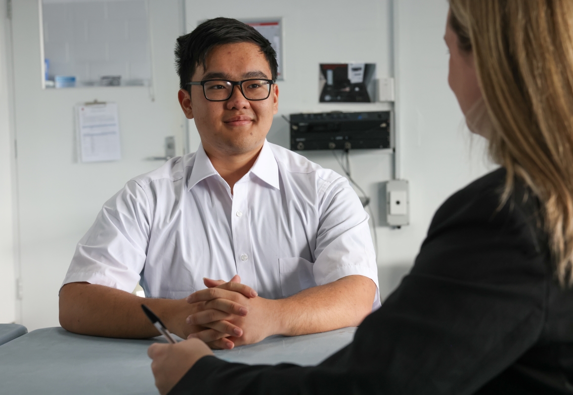 Get Set for Work - Boy sitting in on an interview wearing white business attire