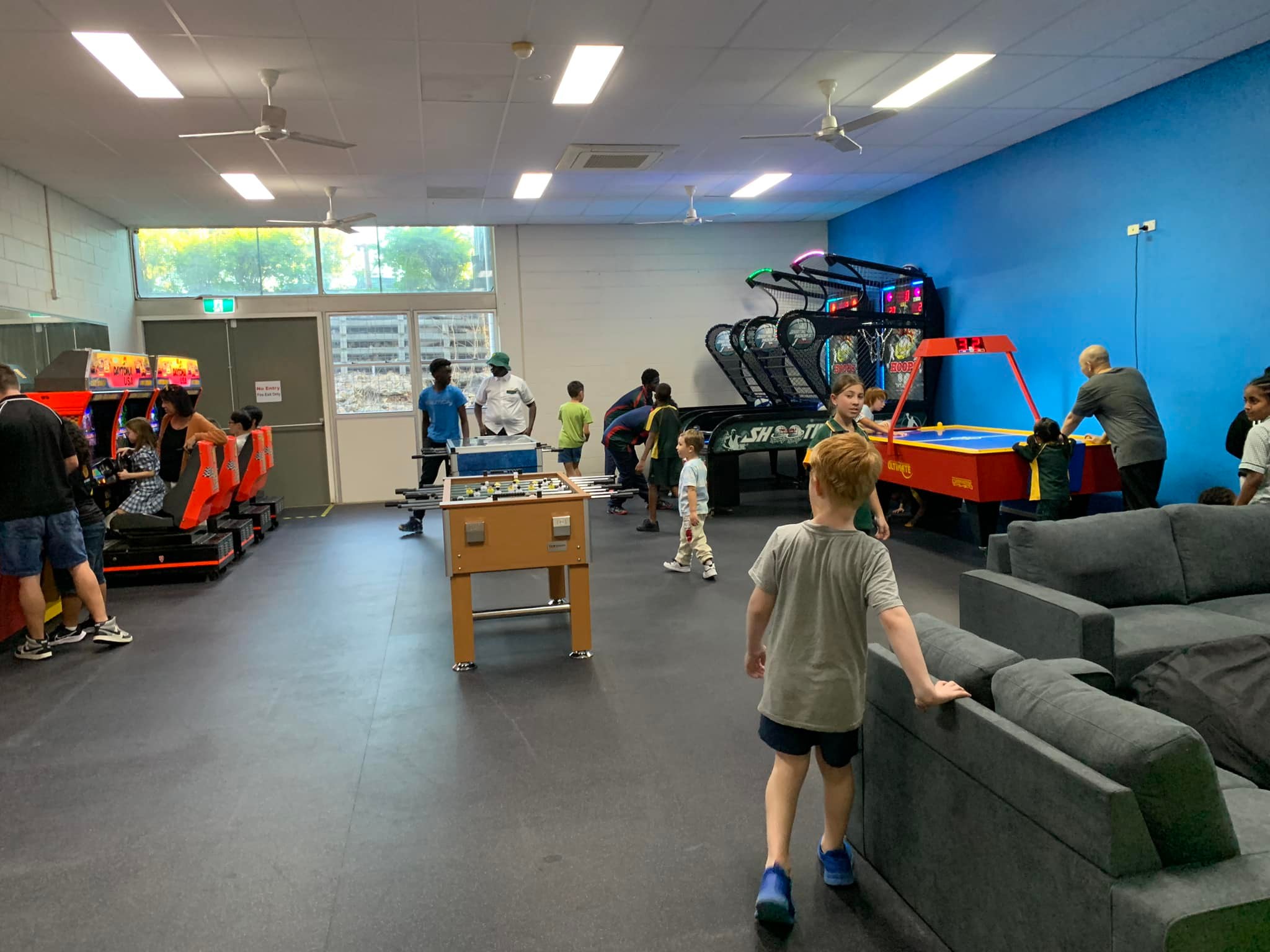 Young people in a youth room playing with an array of activities