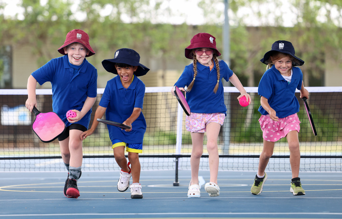 4 children running with pickleball bats