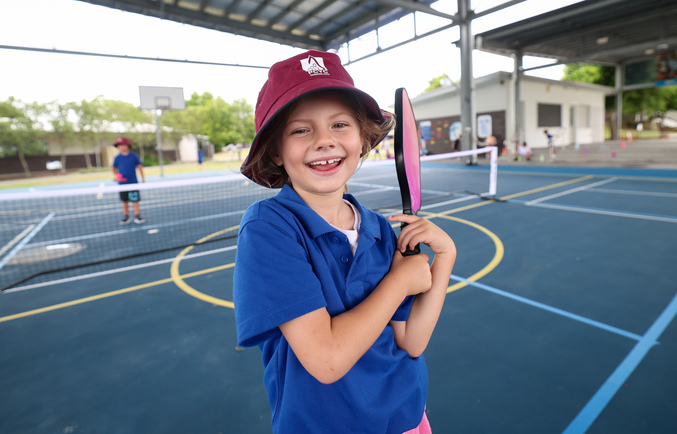 Girl holding pickleball bat