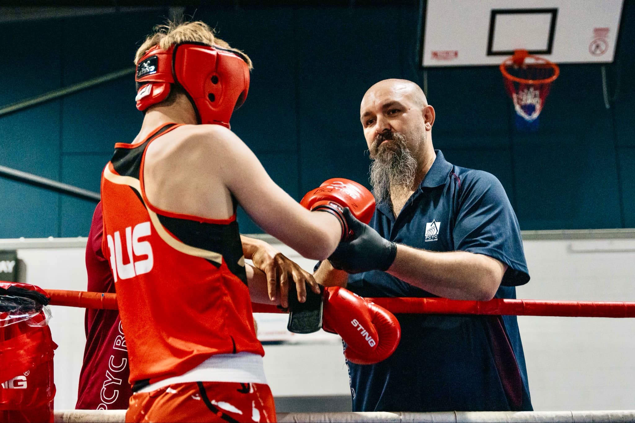 Staff member a boxer talking inside a boxing ring