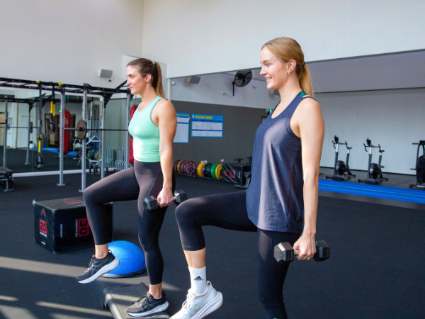 two women in gym working out