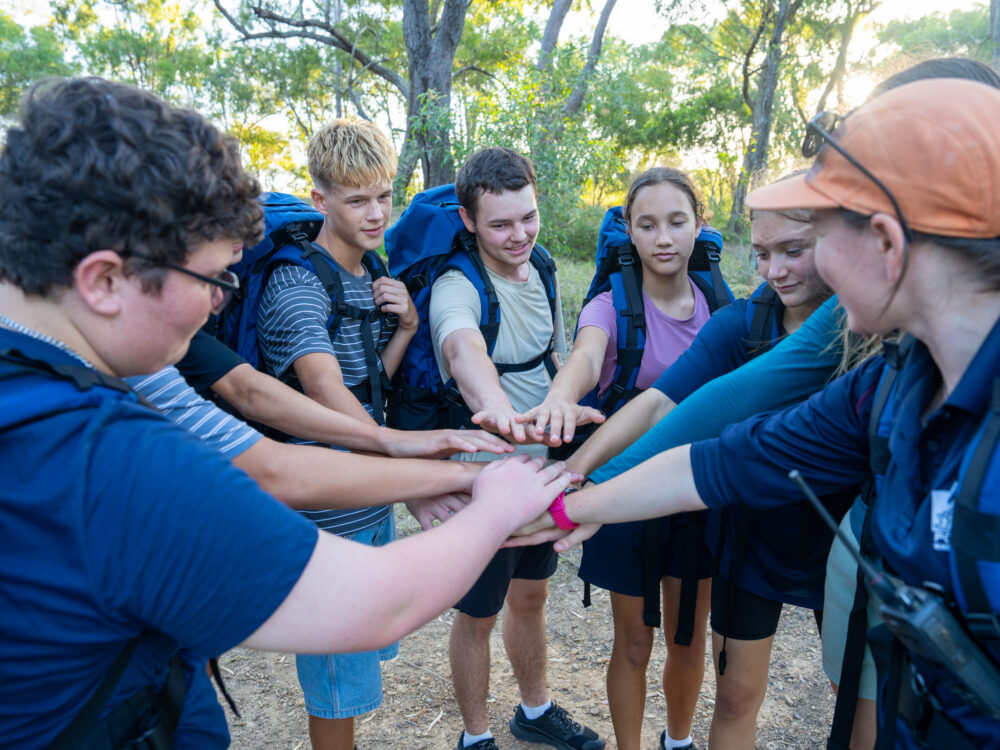 PCYC Staff doing a group huddle with the group