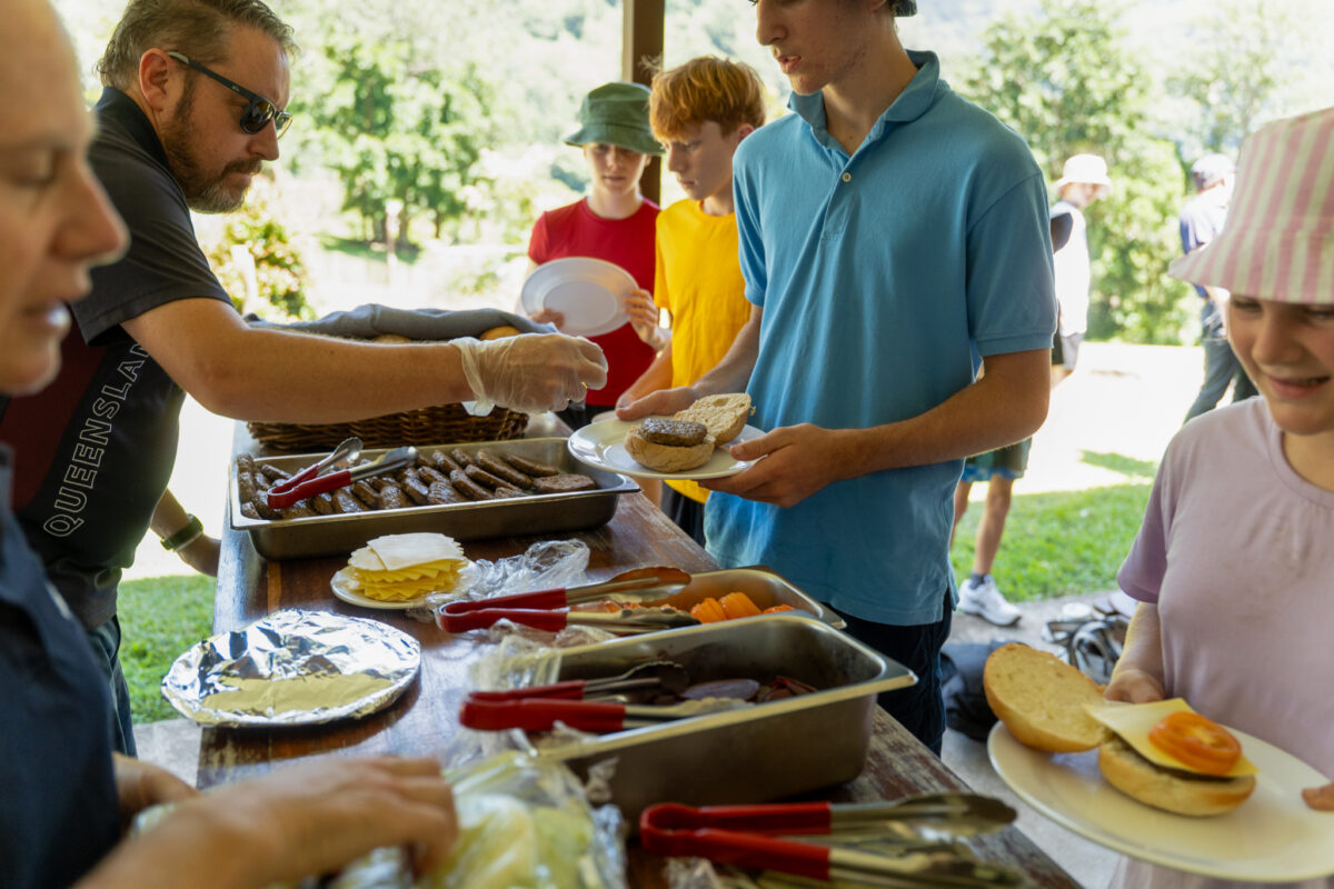 PCYC Staff serving food during lunchtime to the kids