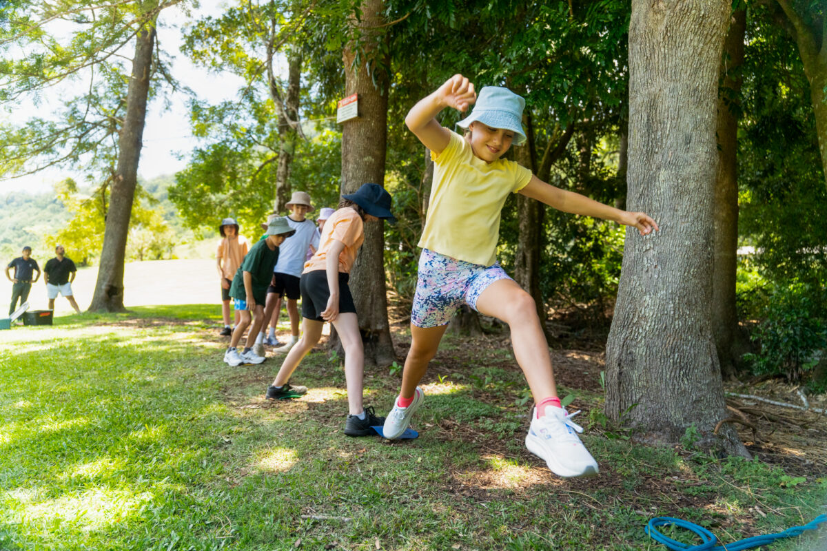 Kid Jumping over rope which doing a group activity