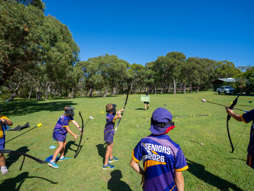 Group of kids practising archery