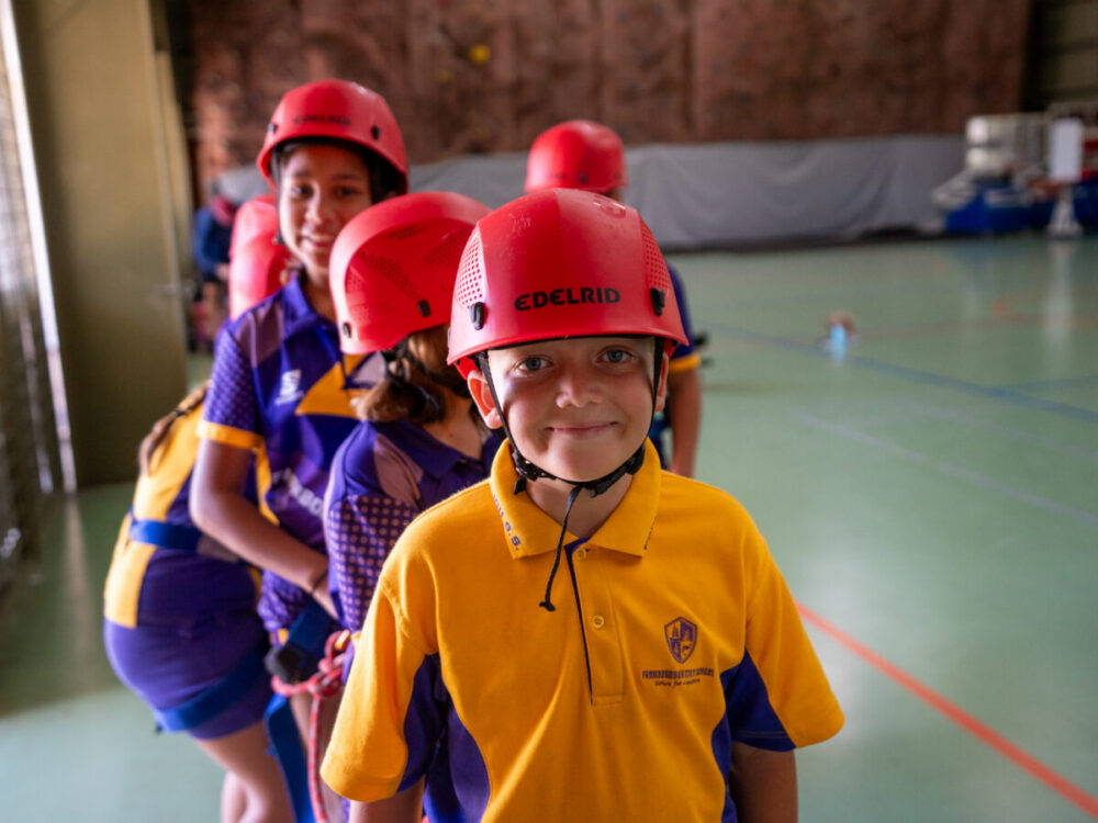 Kids lining up for activity with safety gear