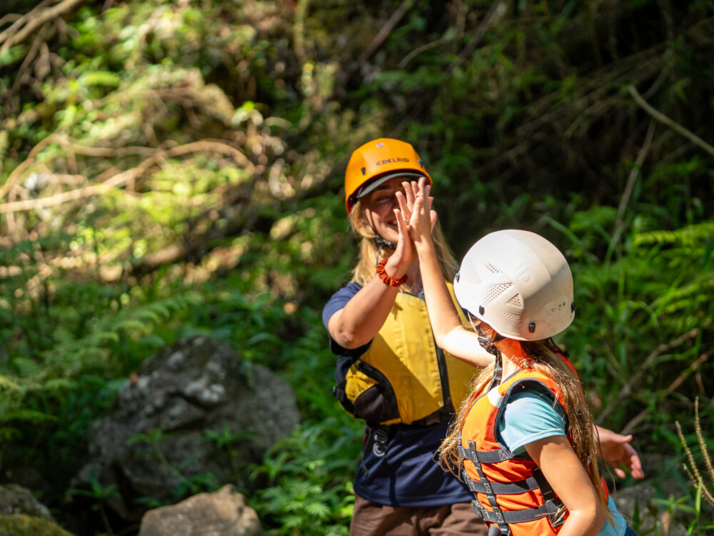 PCYC Staff high fiving a kid