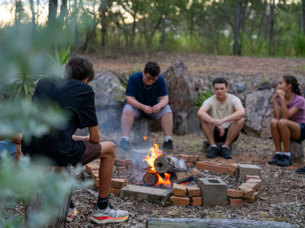 PCYC Youth sitting near the campfire