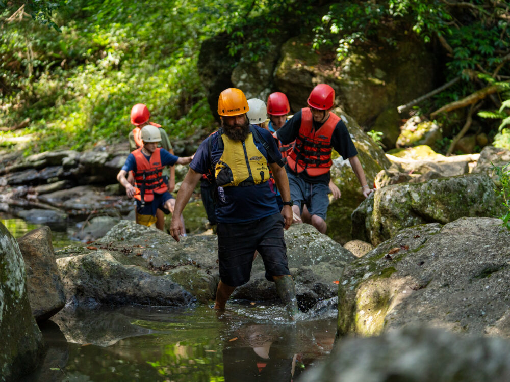 PCYC Staff and youth trekking through the river