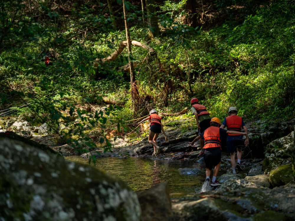 PCYC Staff and Youth trekking through river
